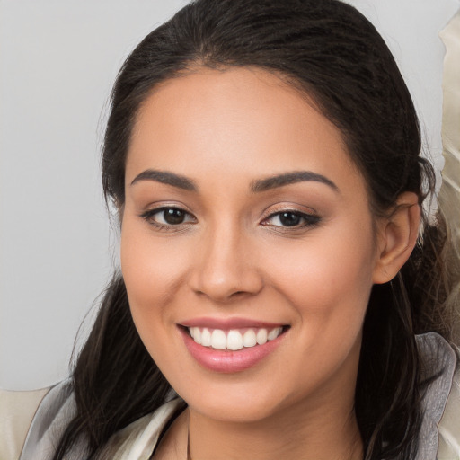 Joyful white young-adult female with long  brown hair and brown eyes