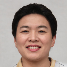 Joyful asian young-adult female with short  black hair and brown eyes