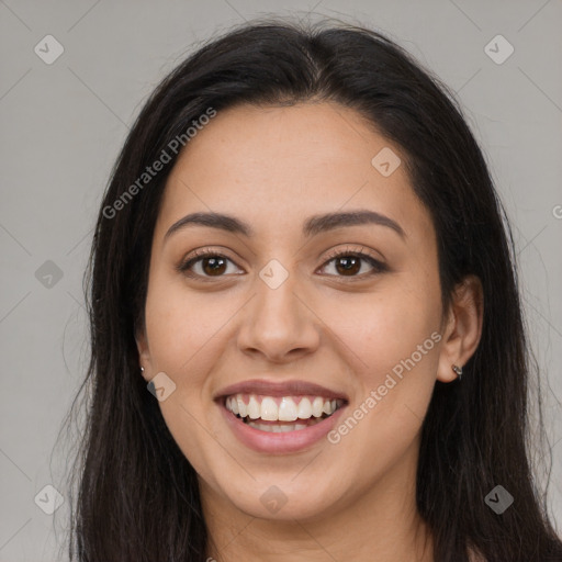 Joyful latino young-adult female with long  brown hair and brown eyes