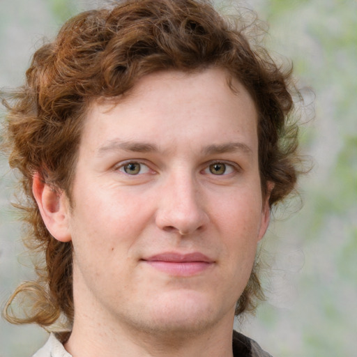 Joyful white young-adult male with medium  brown hair and grey eyes