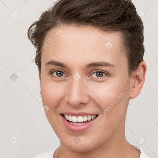 Joyful white young-adult female with short  brown hair and brown eyes