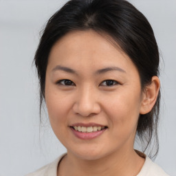 Joyful asian young-adult female with medium  brown hair and brown eyes