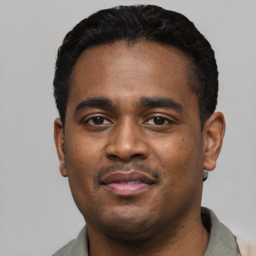 Joyful black young-adult male with short  black hair and brown eyes