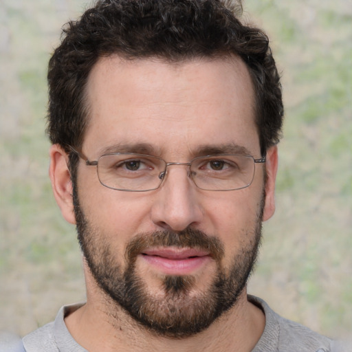 Joyful white adult male with short  brown hair and brown eyes