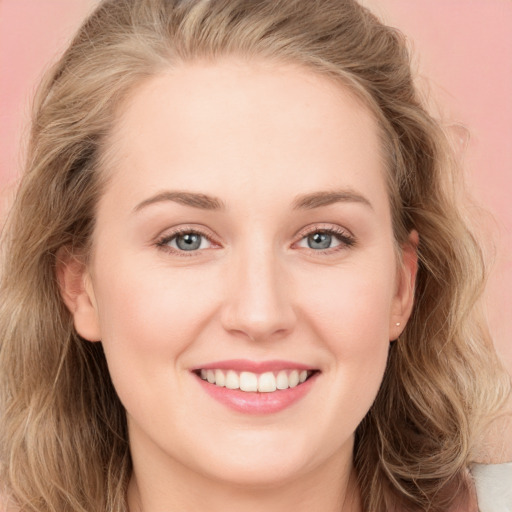 Joyful white young-adult female with long  brown hair and blue eyes