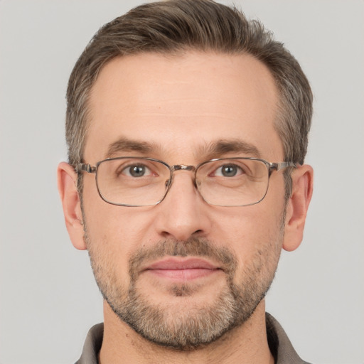 Joyful white adult male with short  brown hair and brown eyes