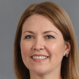 Joyful white adult female with long  brown hair and brown eyes