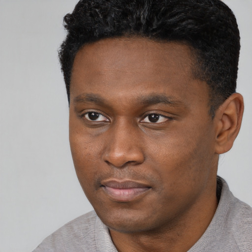 Neutral black young-adult male with short  black hair and brown eyes