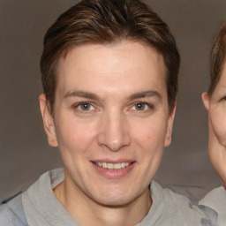 Joyful white adult male with short  brown hair and brown eyes