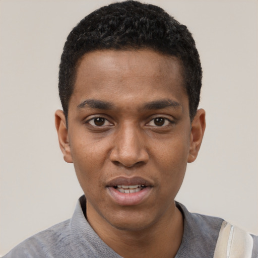 Joyful black young-adult male with short  black hair and brown eyes