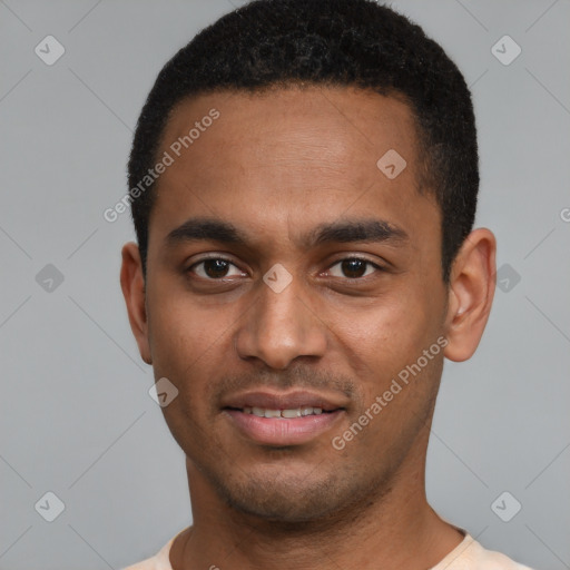 Joyful black young-adult male with short  black hair and brown eyes