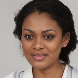 Joyful black young-adult female with medium  brown hair and brown eyes