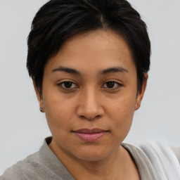 Joyful asian young-adult female with short  brown hair and brown eyes