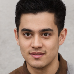 Joyful latino young-adult male with short  brown hair and brown eyes