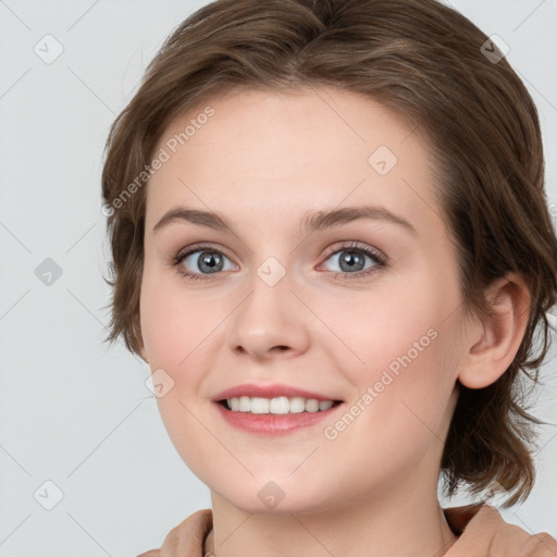 Joyful white young-adult female with medium  brown hair and blue eyes