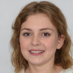 Joyful white young-adult female with medium  brown hair and blue eyes