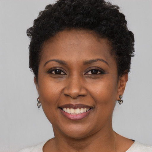 Joyful black young-adult female with short  brown hair and brown eyes