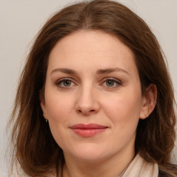 Joyful white adult female with long  brown hair and brown eyes