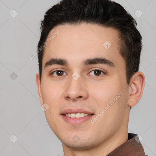 Joyful white young-adult male with short  black hair and brown eyes