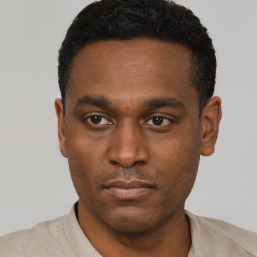 Neutral black young-adult male with short  black hair and brown eyes
