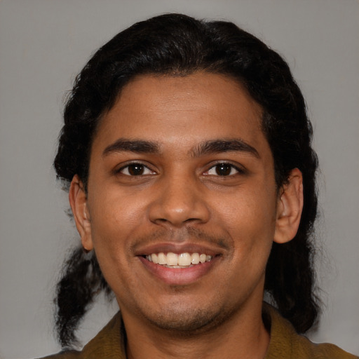 Joyful black young-adult male with short  black hair and brown eyes
