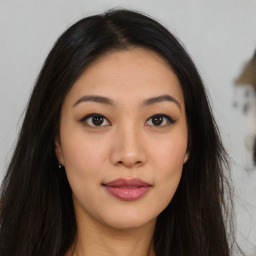 Joyful asian young-adult female with long  brown hair and brown eyes