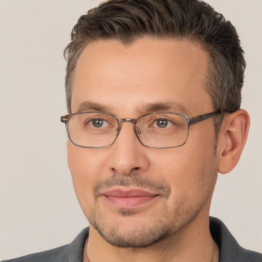 Joyful white adult male with short  brown hair and brown eyes