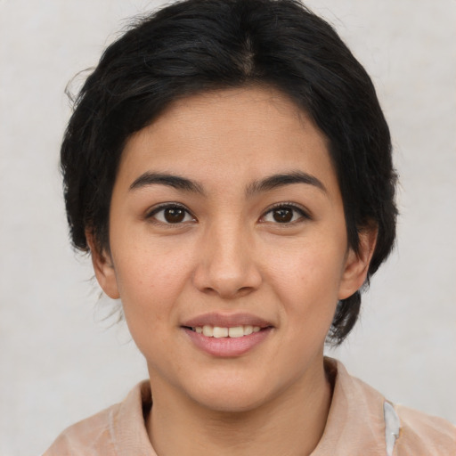 Joyful latino young-adult female with medium  brown hair and brown eyes