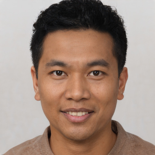 Joyful asian young-adult male with short  black hair and brown eyes