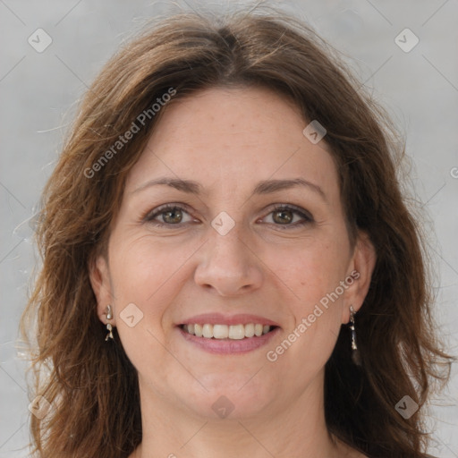 Joyful white adult female with long  brown hair and grey eyes