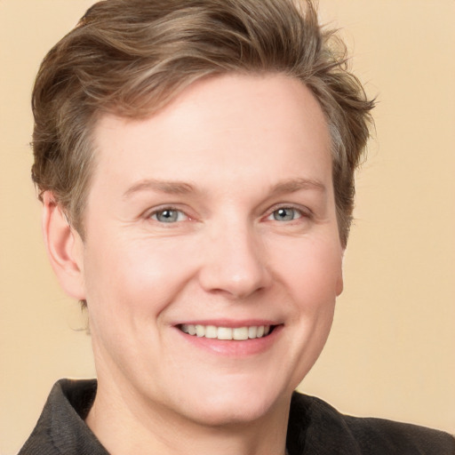 Joyful white adult female with short  brown hair and grey eyes