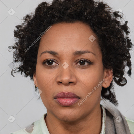 Joyful black adult female with short  brown hair and brown eyes