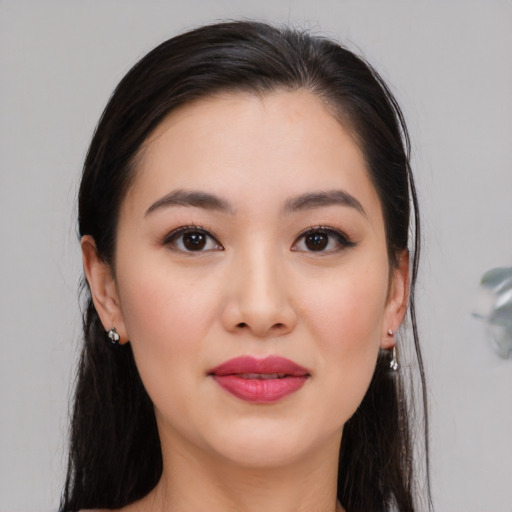 Joyful asian young-adult female with long  black hair and brown eyes