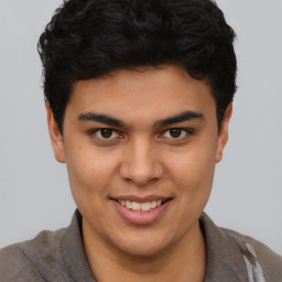 Joyful latino young-adult male with short  brown hair and brown eyes