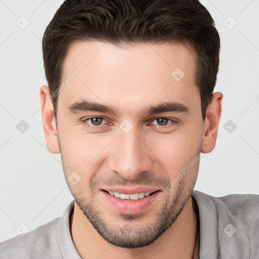 Joyful white young-adult male with short  brown hair and brown eyes