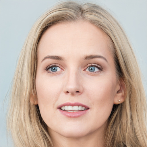 Joyful white young-adult female with long  brown hair and blue eyes