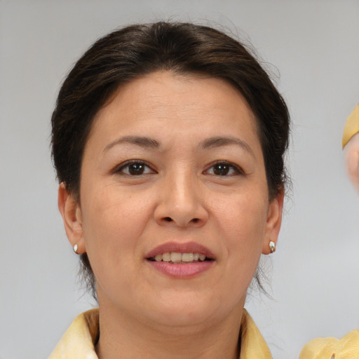 Joyful white adult female with short  brown hair and brown eyes