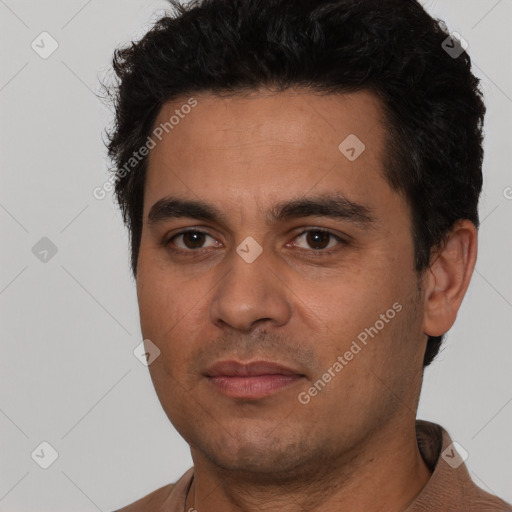 Joyful white young-adult male with short  black hair and brown eyes