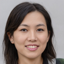 Joyful asian young-adult female with medium  brown hair and brown eyes