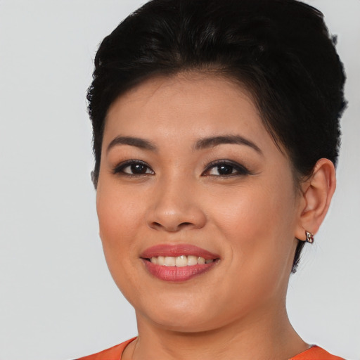 Joyful latino young-adult female with short  brown hair and brown eyes