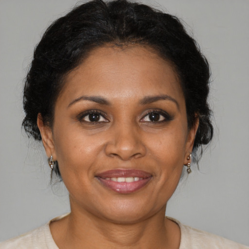 Joyful black young-adult female with medium  brown hair and brown eyes