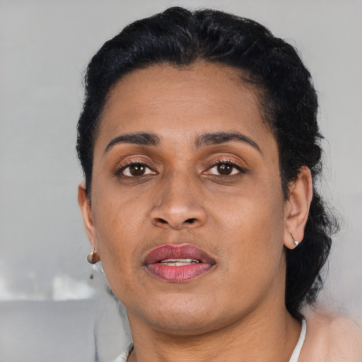 Joyful latino adult female with short  black hair and brown eyes