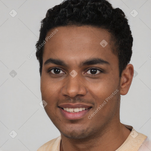 Joyful black young-adult male with short  brown hair and brown eyes