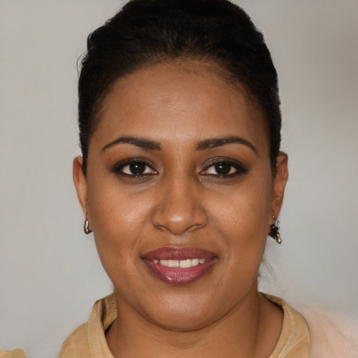 Joyful black young-adult female with short  brown hair and brown eyes