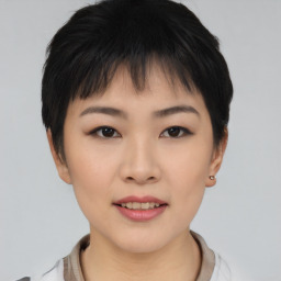 Joyful asian young-adult female with short  black hair and brown eyes