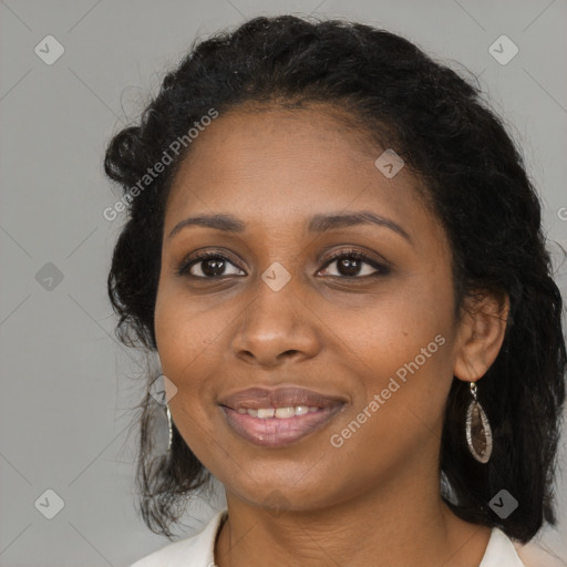 Joyful black young-adult female with long  brown hair and brown eyes