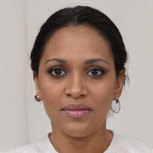 Joyful black young-adult female with short  brown hair and brown eyes