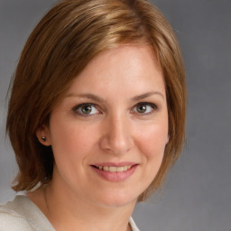 Joyful white young-adult female with medium  brown hair and blue eyes