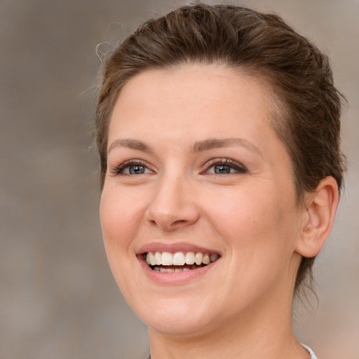 Joyful white young-adult female with medium  brown hair and brown eyes