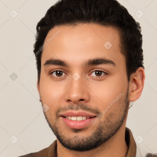 Joyful white young-adult male with short  black hair and brown eyes